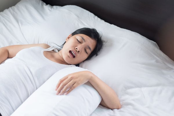 Female snoring while sleeping on bed, Woman snoring because due to tired of work